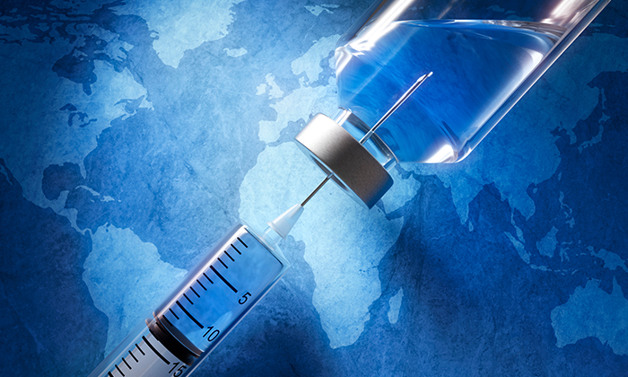 Image of syringe being filled, with a world map in the backdrop.