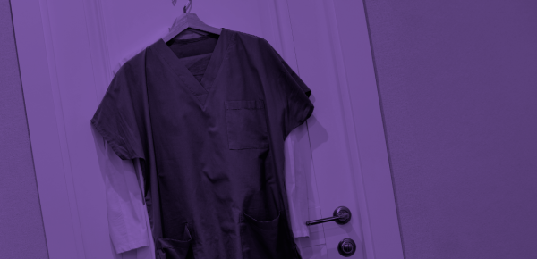 physicians coat hanging on door rack